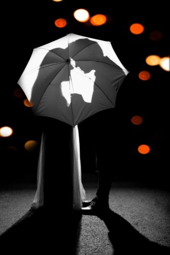 Lovely couple behind umbrella
